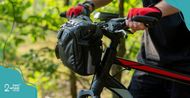 a man holding a bike with a handlebar bag in the middle