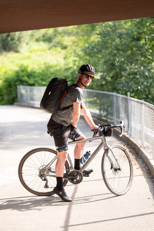 Two Wheel Gear Spin Backpack Messenger Bag on Man riding bicycle