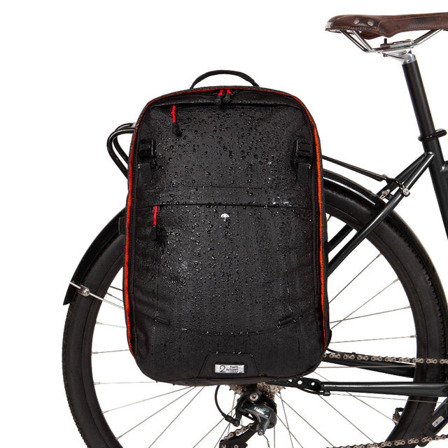 Weatherproof Two Wheel Gear Pannier Backpack Convertible 2.0 LITE (22L) in Black Ripstop attached to bike for commuting in the rain