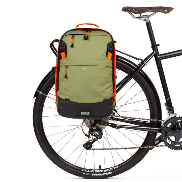 Weatherproof Two Wheel Gear Pannier Backpack Convertible 2.0 LITE (22L) in olive green attached to bike for commuting