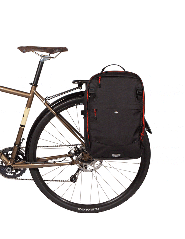 Weatherproof Two Wheel Gear Pannier Backpack Convertible 2.0 LITE (22L) in Black Ripstop attached to bike for commuting with reflective Rain Cover