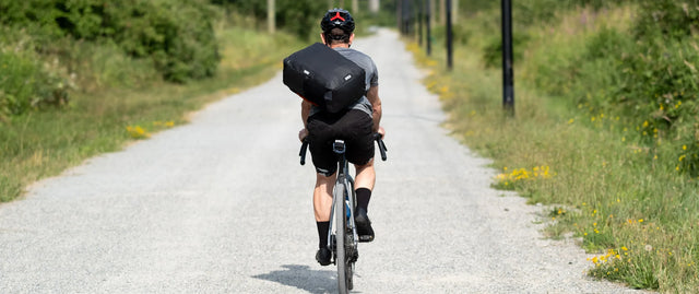 Two Wheel Gear man riding bicycle with messenger bag