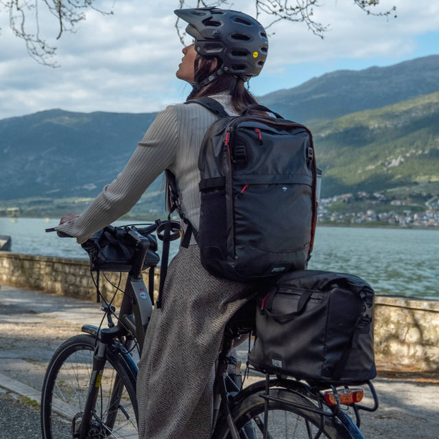 Two Wheel Gear - Woman riding bicycle with bags